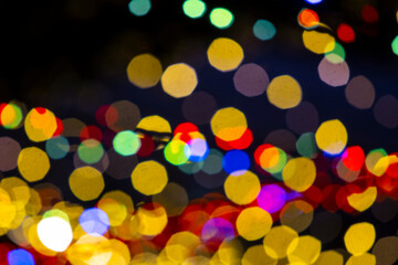 Holiday lights in out of focus. Christmas lights. Holiday background. Winter illuminations.