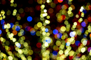 Holiday lights in out of focus. Christmas lights. Holiday background. Winter illuminations.