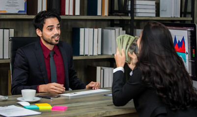 Closeup shot of Millennial Indian Asian professional successful executive bearded male businessman manager entrepreneur in formal suit sitting smiling shaking hands with businesswoman colleague