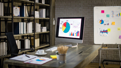 Empty business company having presentation computer with corporate statistics. On conference table standing financial graphs documents.