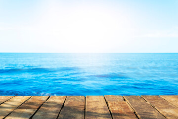 Beautiful wooden floor and blue background, sea water and sky.