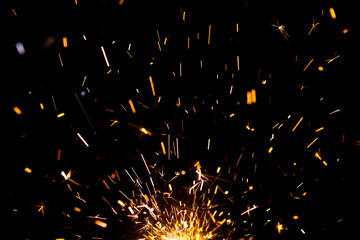 Sparks from firework in front of black backgound