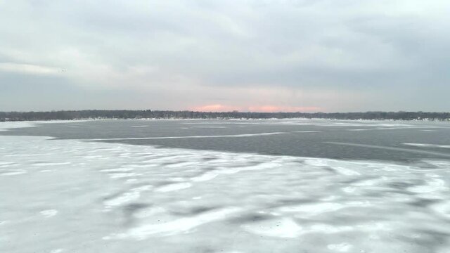 Aerial view of a lake frozen ice layer and intersting patterns on nature