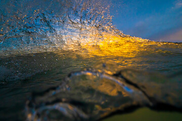 Ocean Wave detail with sunset light illuminating the water