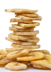 A stack of banana chips stands on a bunch of chips.