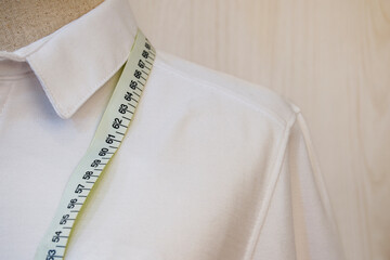 Close up mannequin with white shirt and waist measuring tape