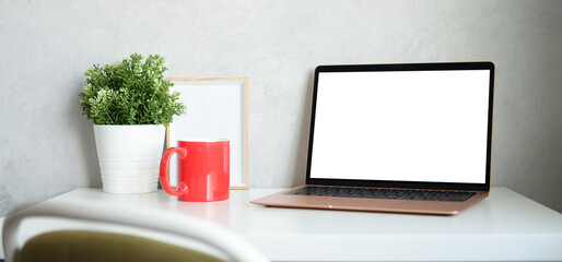Home office desk with laptop computer, notebook and smart phone.