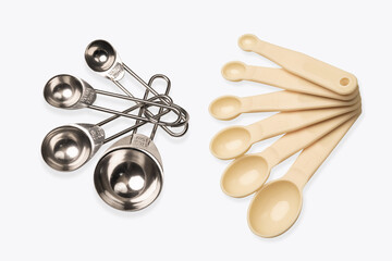 measuring spoon on white background ,Measuring spoons made of plastic or metal and many sizes .