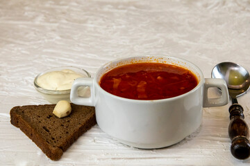 Ukrainian borsch. Traditional dish of Ukraine. Red borscht on a white plate.