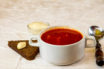 Ukrainian borsch. Traditional dish of Ukraine. Red borscht on a white plate.