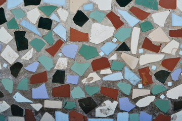 Mosaic wall decorative ornament from ceramic broken tiles, decorative ornament. Colorful wall background.