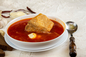 Ukrainian borsch. Traditional dish of Ukraine. Red borscht on a white plate.