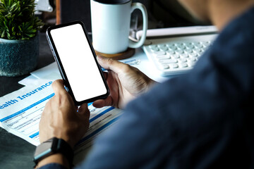 Close up view of businessman holding mock up smart phone with blank screen.	

