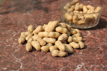 Bunch of dried peanuts on tile
