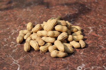 Bunch of dried peanuts on tile