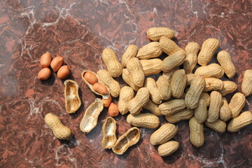 Bunch of peeled peanuts on tile view from above