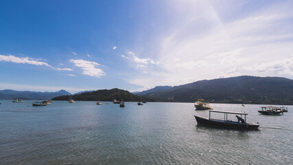 Boats in the blue sea under blue cloudy sky