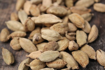 Dried cardamom on a wooden background