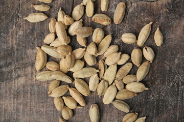 Dried cardamom on a wooden background