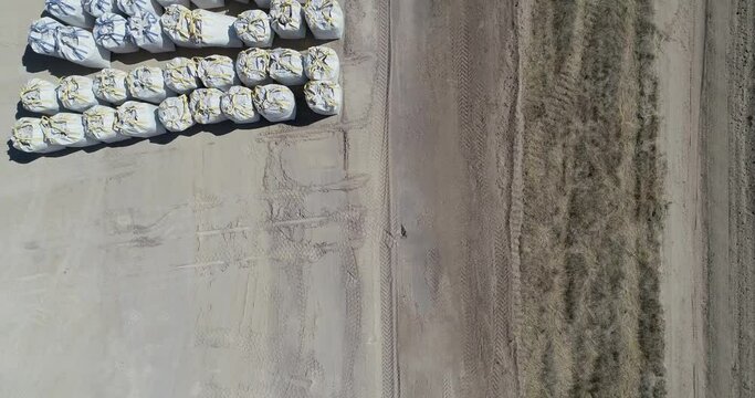 Downshot over fracking pad showing equipment and supplies. Drone 4K 60fps