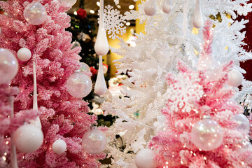 A colorful and bright Christmas tree in white, red, and pink like snow.