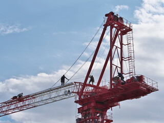 Tokyo,Japan - October 25, 2021: Assembly of a tower crane. Connecting a jib with the tower.
