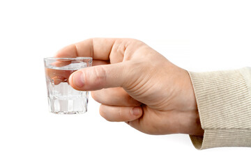 A glass of alcohol in a person's hand on a white background.