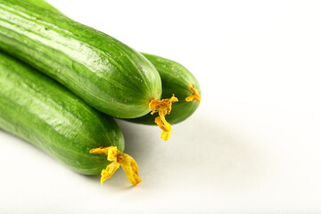 Fresh green  cucumbers on a white background. vegetarian raw foods.