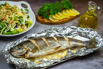 Oven baked trout in foil and salad. 