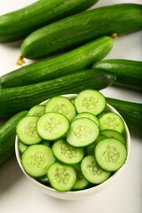 Healthy vegan diet appetizer foods- bowl of delicious fresg green cucumber salad with herbs.