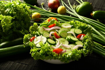 Fresh green cucumber salad, garnished with tomatoes, onions,herbs.