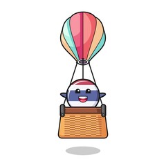 thailand flag mascot riding a hot air balloon