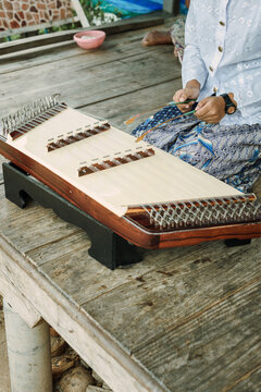 Thai girl playing Khim, the traditional Thai music Instrument. Leisure and hobby