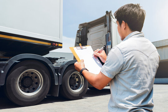 Asian Truck Driver is Checking the Truck's Safety Maintenance Checklist. Lorry Driver. Inspection Truck Safety  Semi Truck Wheels and Tires. Shipping Cargo Freight Truck Transport Logistics. 	