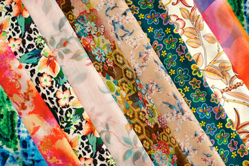 Layers of beautiful silk fabric. Many different colorful fabrics are folded as a background....