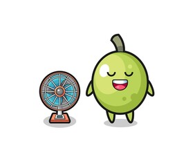 cute olive is standing in front of the fan