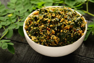 Moringa oleifera leaves stir fry with coconut , spices, herbs, Kerala vegetarian cooking recipes. 