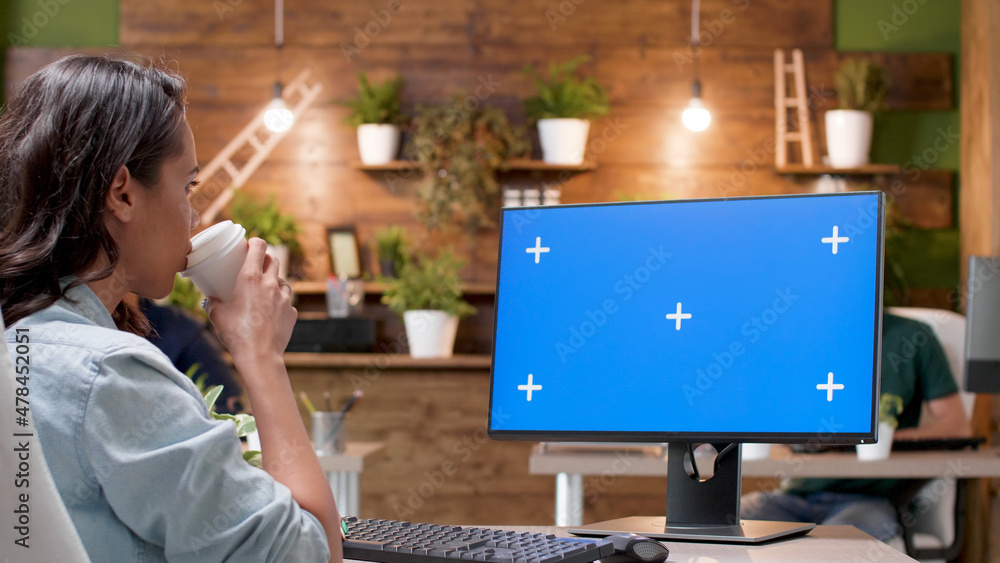 Poster businesswoman looking at mock up green screen chroma key computer with isolated display analyzing ma