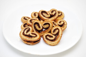 selective focus, Cinnamon sugar palmiers on white plate.