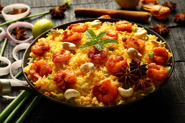 Bowl of delicious, spicy cooked seafood biryani, pilaf, Asian traditional recipes background.