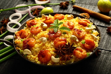Bowl of delicious, spicy cooked seafood biryani, pilaf, Asian traditional recipes background.