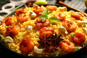 Bowl of delicious, spicy cooked seafood biryani, pilaf, Asian traditional recipes background.