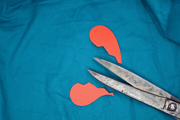 red paper heart cut with scissors