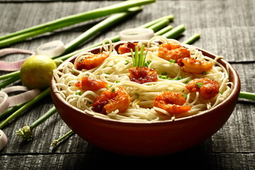 Asian street foods- delicious and spicy cooked seafood noodles with shrimps and prawns. traditional non vegetarian  recipes.