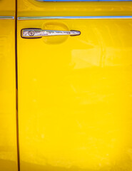 vivid yellow car door and chrome handle, space for your text