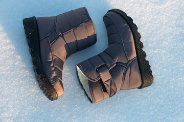 winter puffy women's boots for walking in the snow in frost
