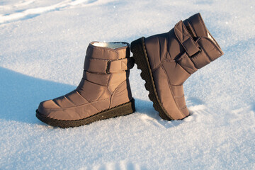 winter puffy women's boots for walking in the snow in frost, on the snow