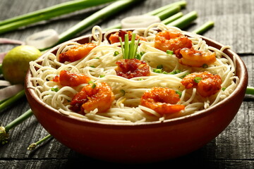 Homemade delicious seafood pasta with fresh shrimps, Asian cooking recipes backgrounds.