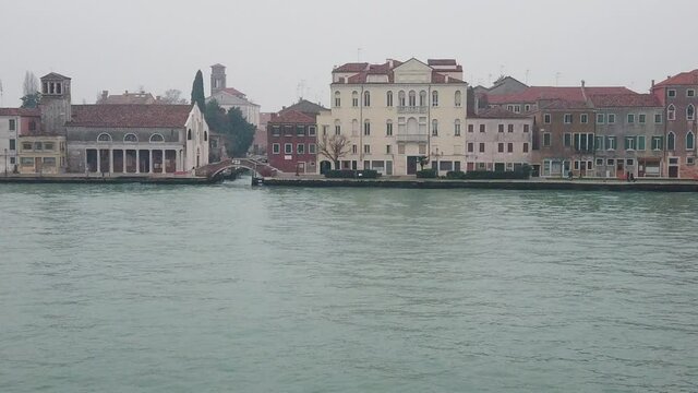 Venice, Italy - January 2022 - Traveling on the ferry that transports cars, along the Giudecca canal, among the splendid historic buildings of the lagoon city