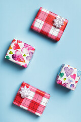 Boxes with gifts on a blue background. Mother's day valentine. Flat lay, top view